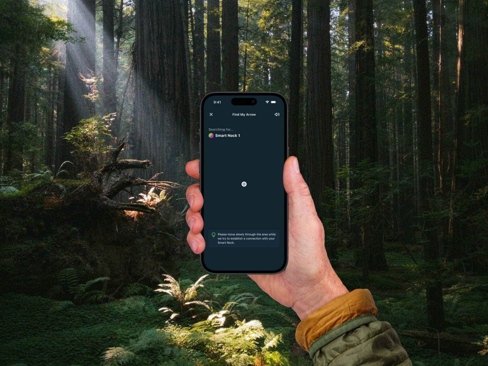 A hand holds a phone in a redwood forest, with Find My Arrow searching for Smart Nock 1 and a tip to move slowly through the area.